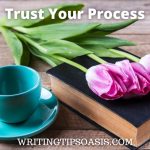 Image cup of coffee and tulips on a book and title which is trust your process.