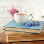 Image of books, flower, and cup of coffee.